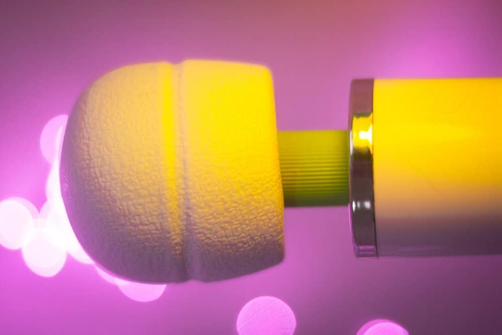 Yellow Massager sex toy in a purple background