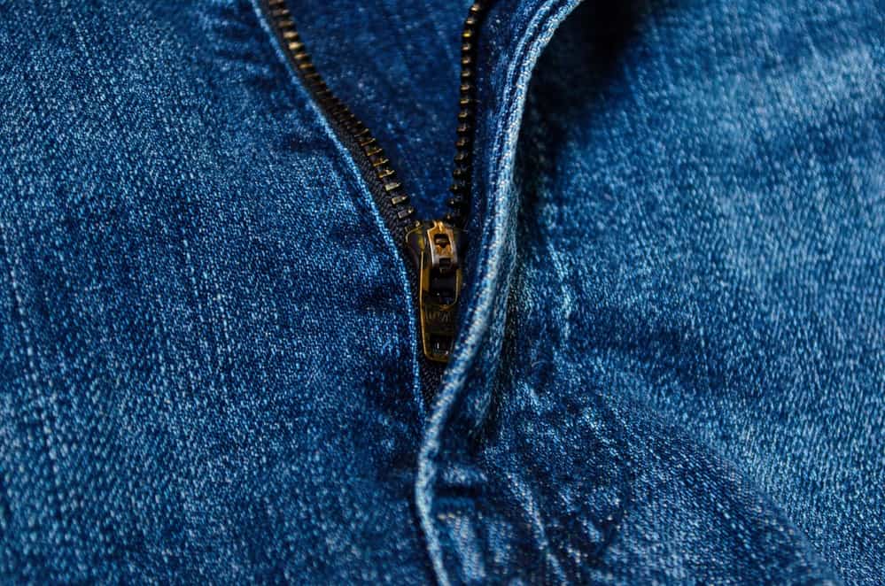 A pair of jeans with the zip partially undone