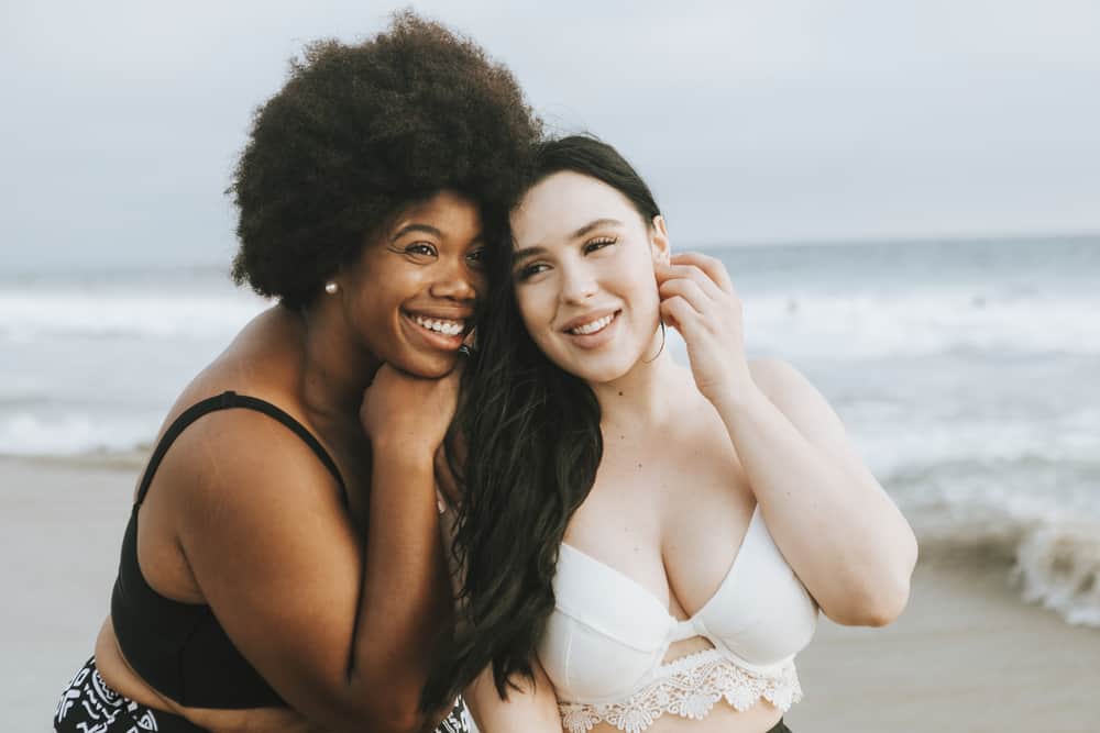 smiling plus size women at a beach