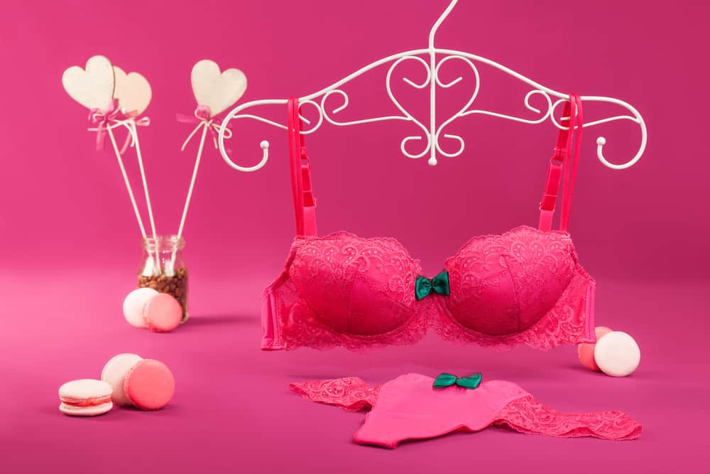 pink bra and panty set over a pink background