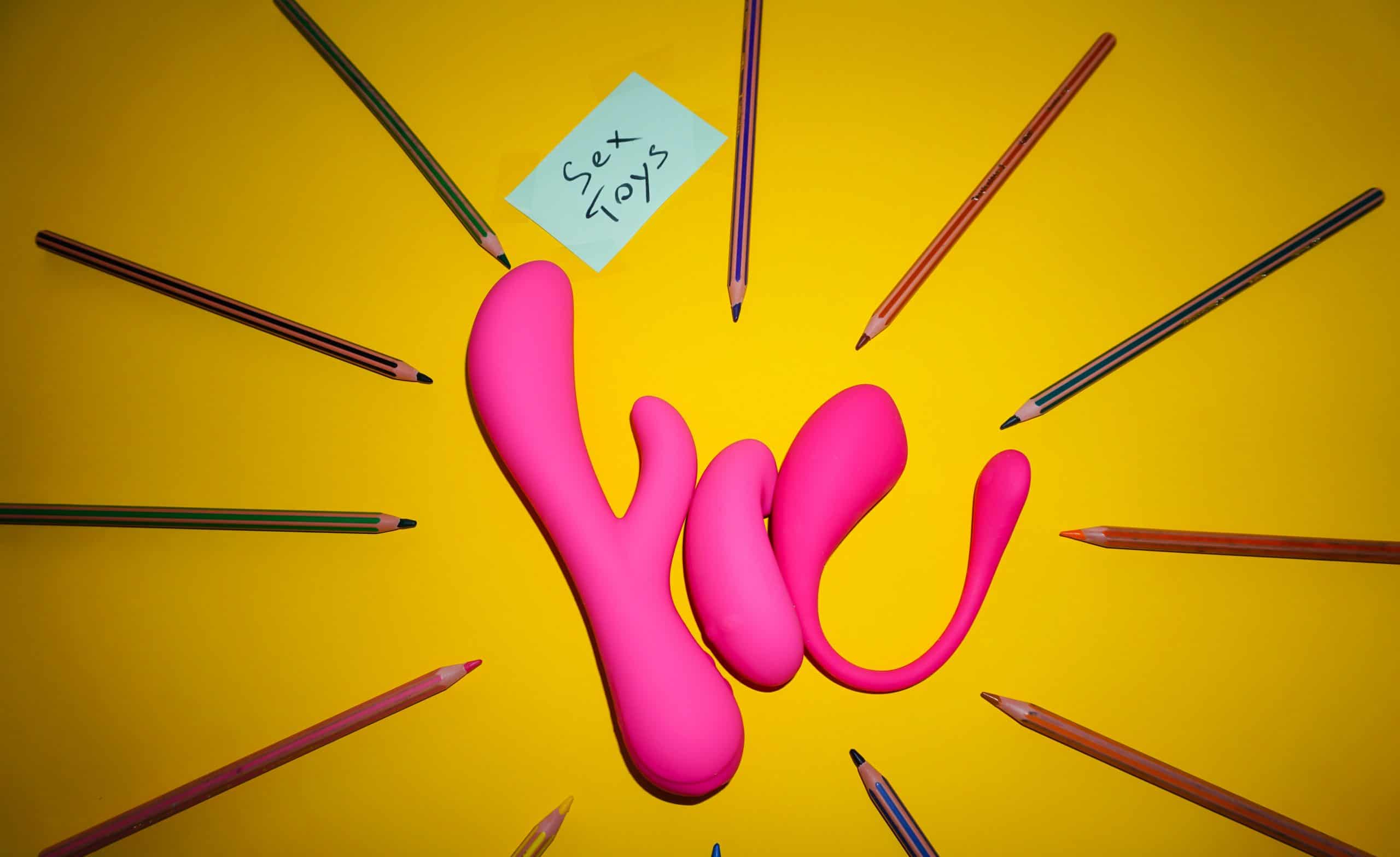pencils and sex toys in a yellow background