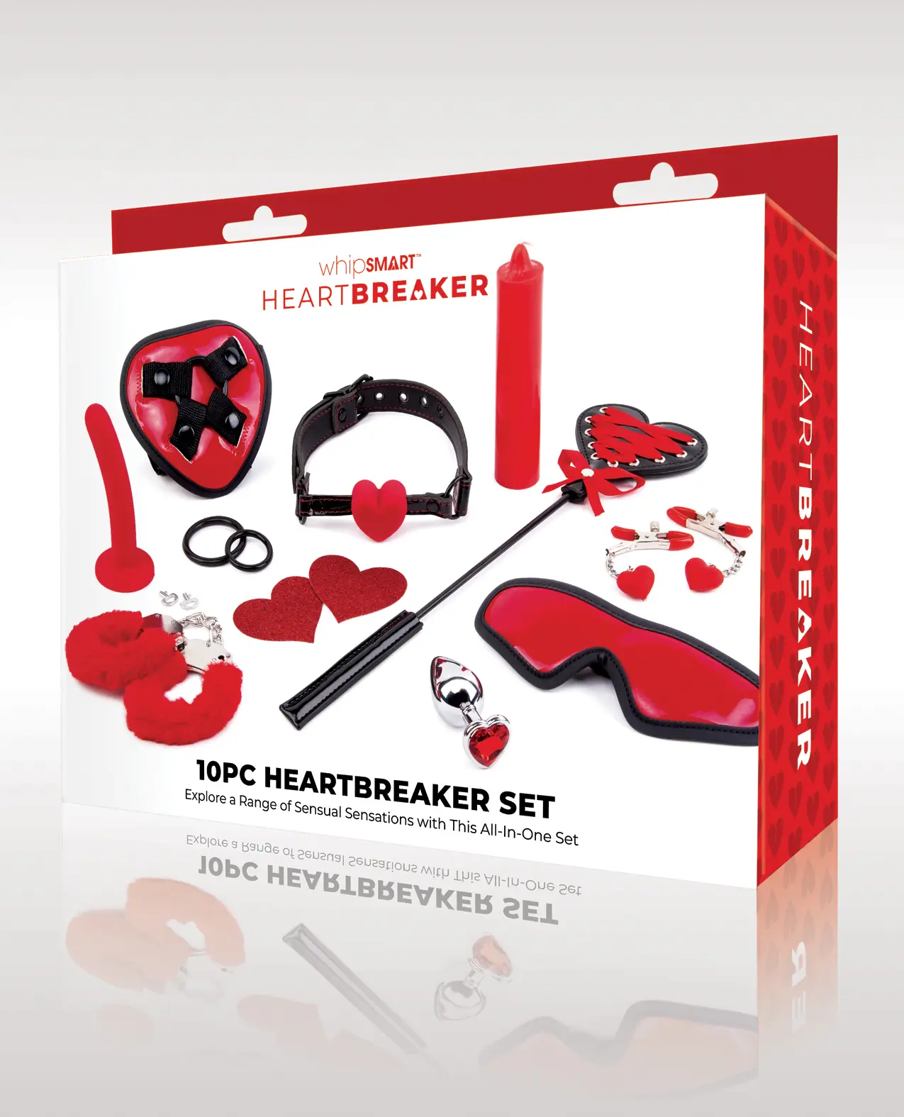 white and red box picturing the contents of the package. Includes a Red Heart-shaped  Harness, Silicone Dildo 5 inches, Ball Gag, Heart Shaped Pasties, Heart Shapes Crop, Red Mask, furry hand/ankle cuffs, Metal Butt Plug with a heart-shaped jewel, Hot Wax Candle, cock ring 