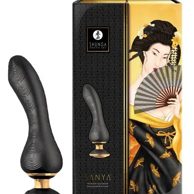 Shunga Sanya sits next to the package which has a image of the toy and a woman using a hand fan